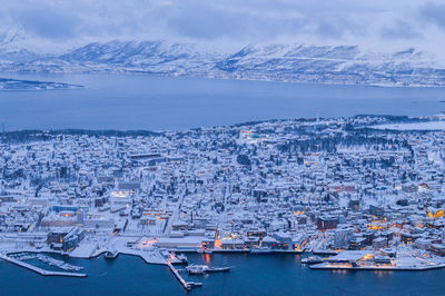 High angle view of townscape by sea against sky