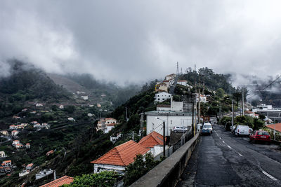 High angle view of cars on road against storm clouds