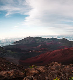 Scenic view of mountains against cloudy sky