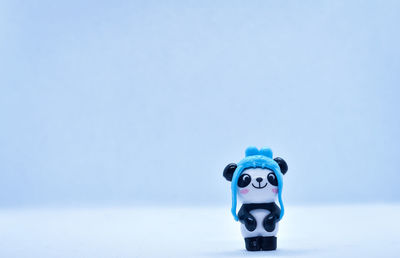 Toy car on snow against blue sky