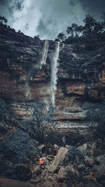 Scenic view of waterfall against sky