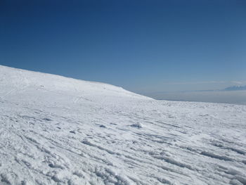 Scenic view of snow against blue sky