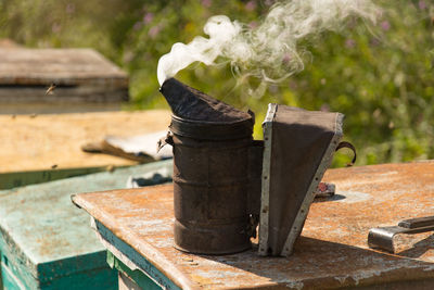 Close-up of smoke emitting from old metallic container