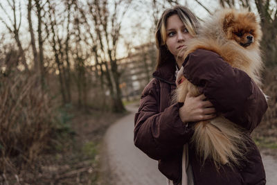 Teens girl with pomeranian fluffy dog