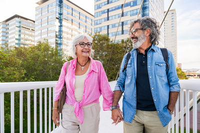 Portrait of smiling couple standing in city