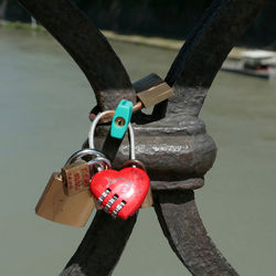 Close-up of padlocks hanging on metal