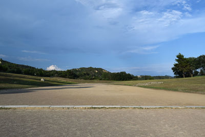 Road by landscape against sky