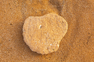 High angle view of heart shape on sand