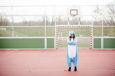 Rear view of woman standing on field