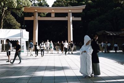 Group of people walking outside temple