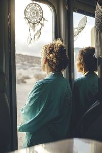 Rear view of people sitting in train