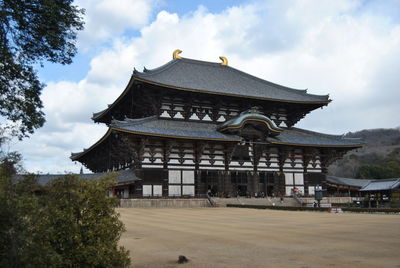 View of temple building against cloudy sky