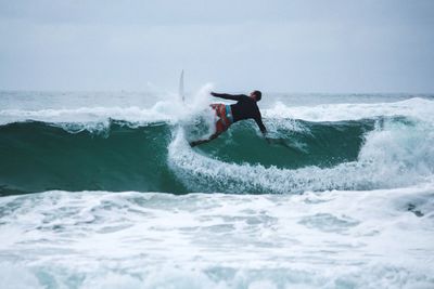 People surfing in sea