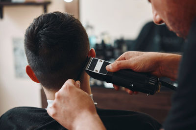 Side view of man using mobile phone