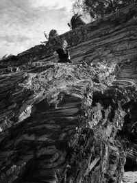 Low angle view of rock formation against sky