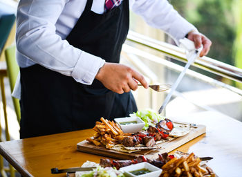 Midsection of man preparing food