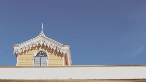 Low angle view of building against clear blue sky