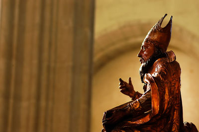 Low angle view of statue against building