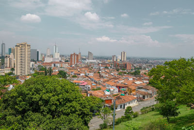 High angle view of buildings and trees against sky
