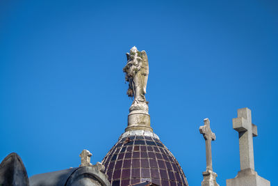 Low angle view of statue against clear blue sky