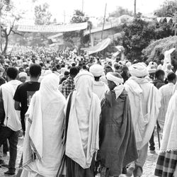 Rear view of people standing in city