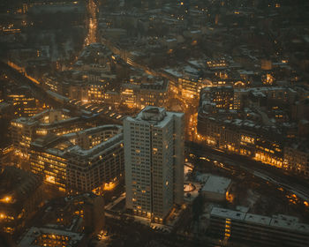 High angle view of city lit up at night