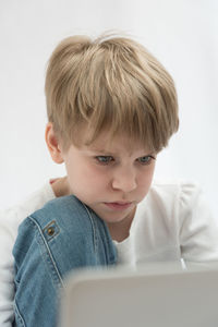 Portrait of cute boy using mobile phone