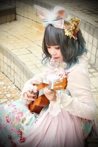 High angle view of girl playing music 