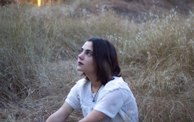 Side view of woman looking away on field