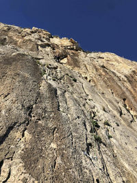 Low angle view of rock formation against sky