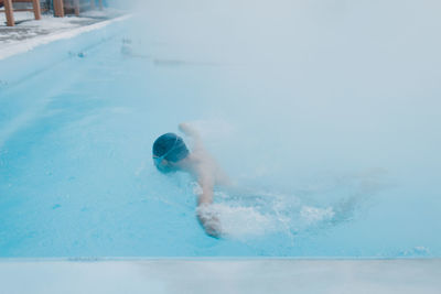 Man swimming in pool