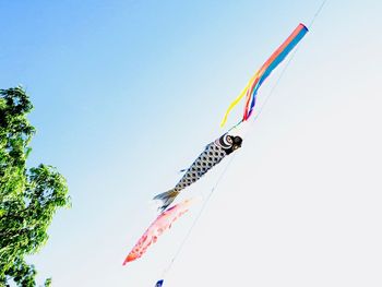 Low angle view of flags against clear sky