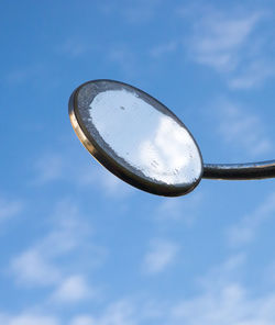 Low angle view of metal against sky