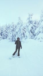 Person with snowboard on snow covered field