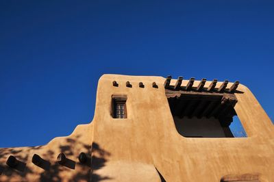 Low angle view of old-fashioned house against clear sky