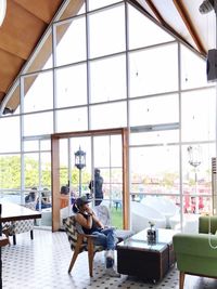 Woman sitting on chair in modern building