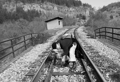Man photographing on railroad tracks