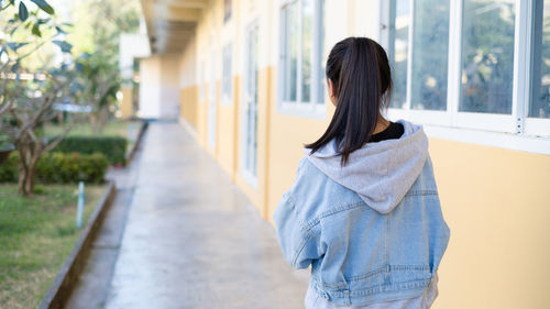 Rear view of woman standing in city