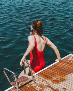 Rear view of man on boat in sea