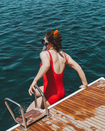 Rear view of woman diving in sea