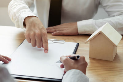 High angle view of man holding hands on table
