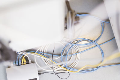 Tangled cable wires with device on table