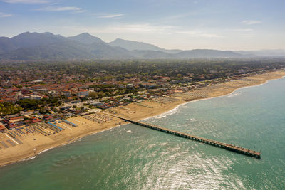 High angle view of sea and mountains against sky