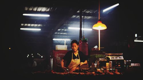 Man working in illuminated room