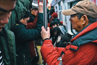 Side view of people looking at city street