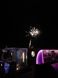 Low angle view of firework display at night