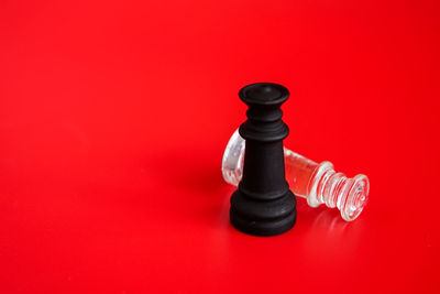 High angle view of chess pieces on red background