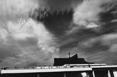 Low angle view of built structure against cloudy sky