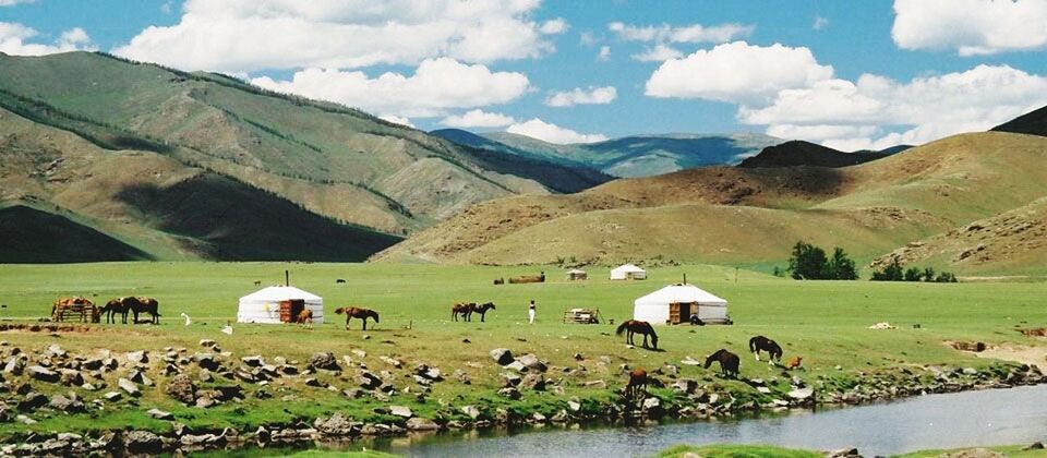 mountain, landscape, mountain range, sky, tranquil scene, tranquility, scenics, beauty in nature, nature, grass, water, non-urban scene, built structure, rock - object, cloud - sky, idyllic, cloud, day, green color, field