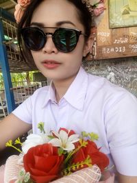 Portrait of girl holding flower bouquet